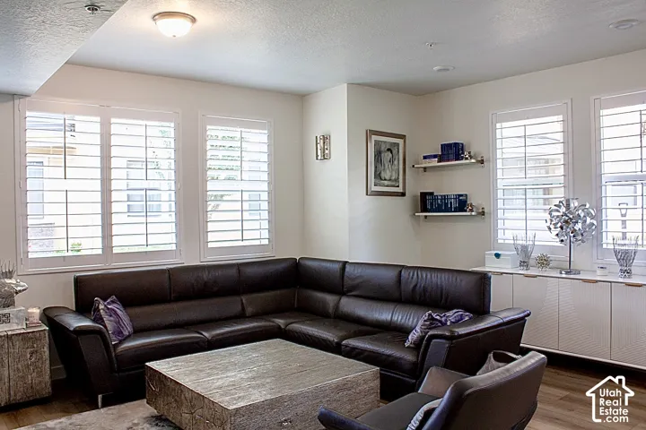 Wall-mounted shelving, recessed lighting, and wood-finish flooring