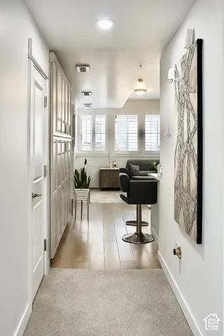 Recessed ceiling lighting, wood-finish flooring, white plantation shutters, built-in cabinetry, and neutral wall tones