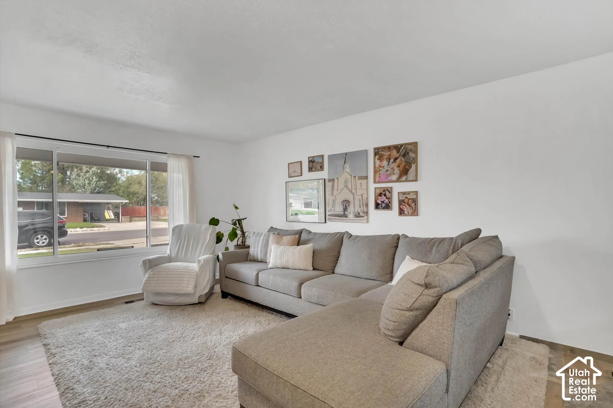 White walls and wood-finish flooring create a bright atmosphere