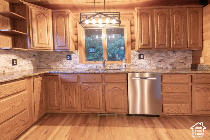 Wood-finish cabinetry with a tiled backsplash