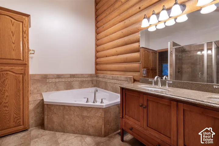 Tile flooring complementing a corner soaking tub with deck-mounted fixtures