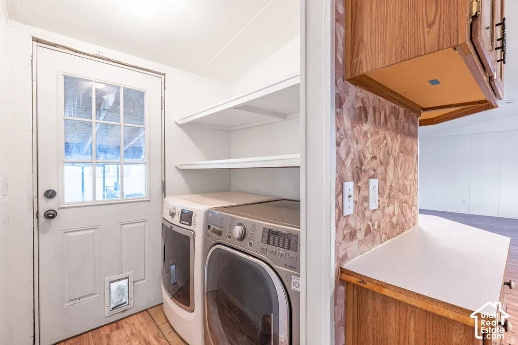White paneled door with nine-light window, wood-finish flooring, and white wall shelving
