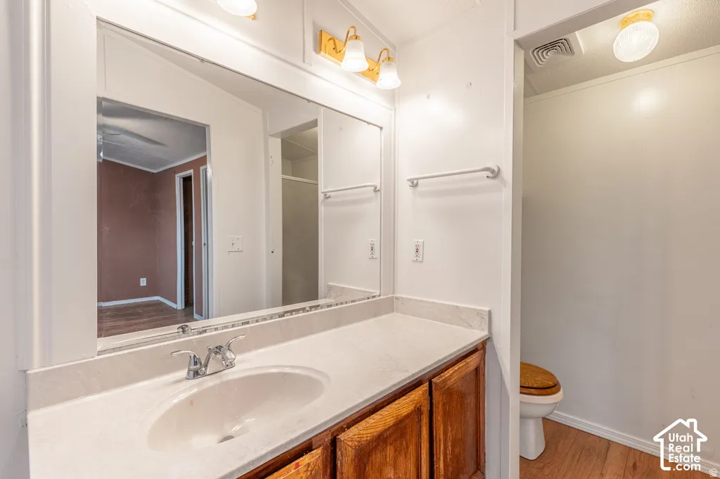 Vanity with integrated sink, chrome faucet, and wood-finish cabinetry