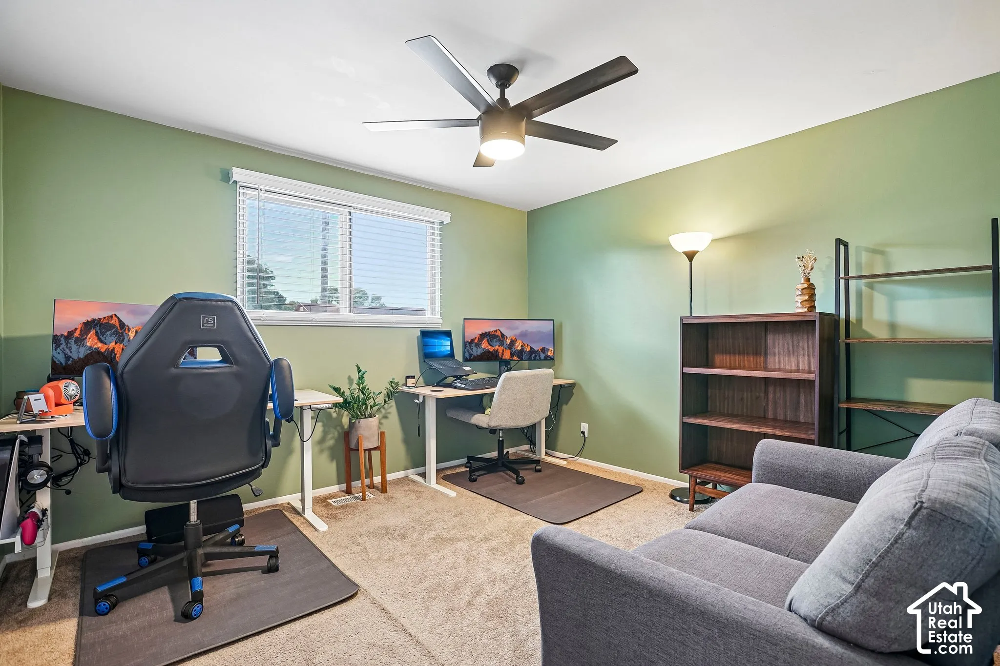 Recessed lighting and a ceiling fan fixture illuminate the space, featuring a window with horizontal blinds
