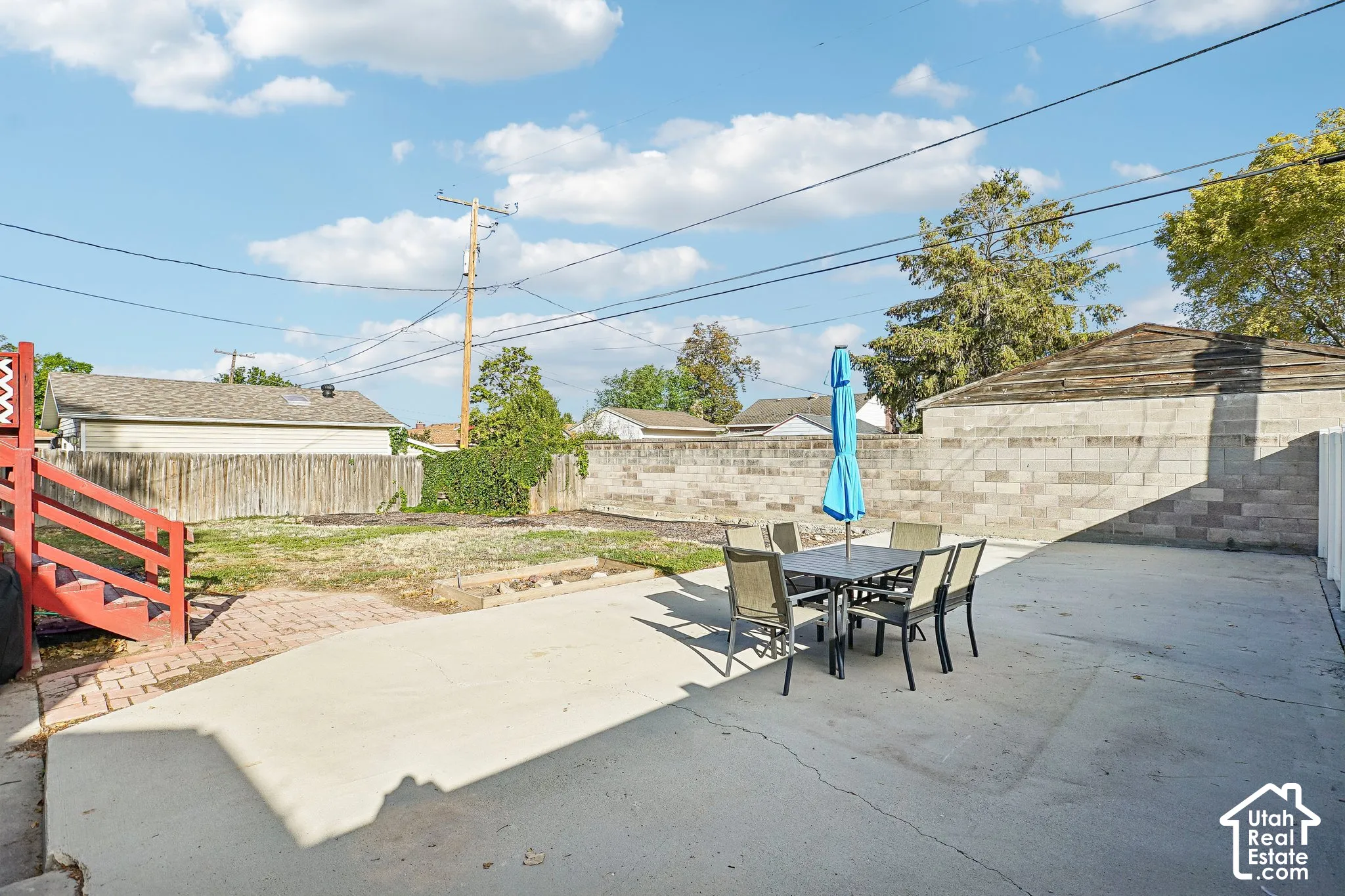Expansive concrete patio with block wall perimeter