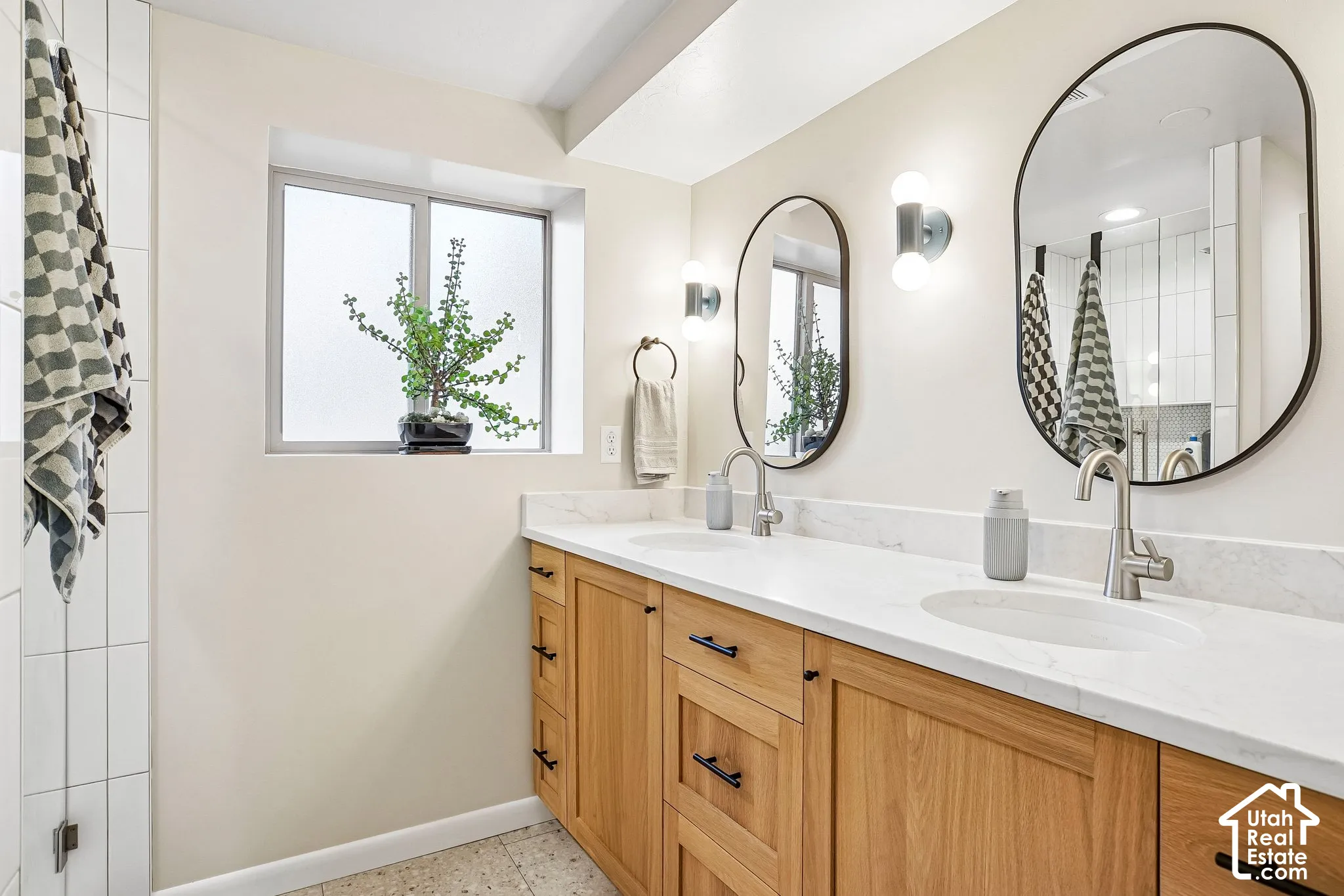 Double vanity with wood cabinetry and black hardware