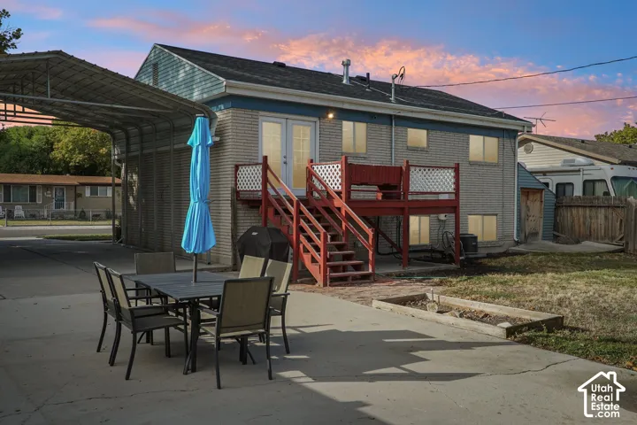 Two-story exterior with brick and siding finishes, featuring a rear deck with staircase access
