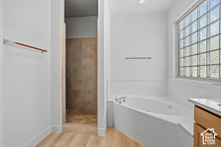 Soaking tub with deck-mounted faucet