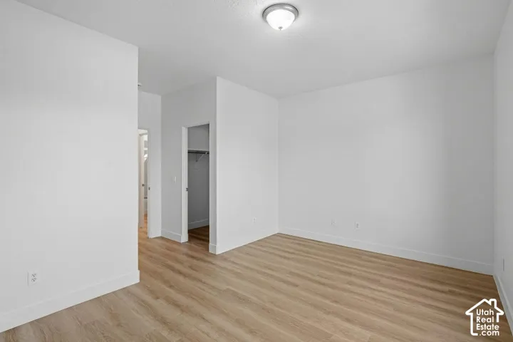 Bright interior space featuring wood-finish flooring and a flush-mount ceiling light