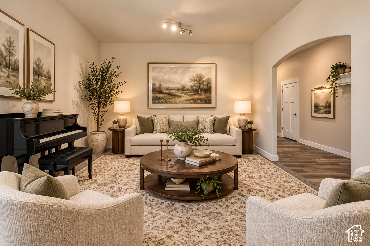 Living area featuring high ceilings, neutral wall tones, arched entryways, multi-panel doors, and wood-finish flooring