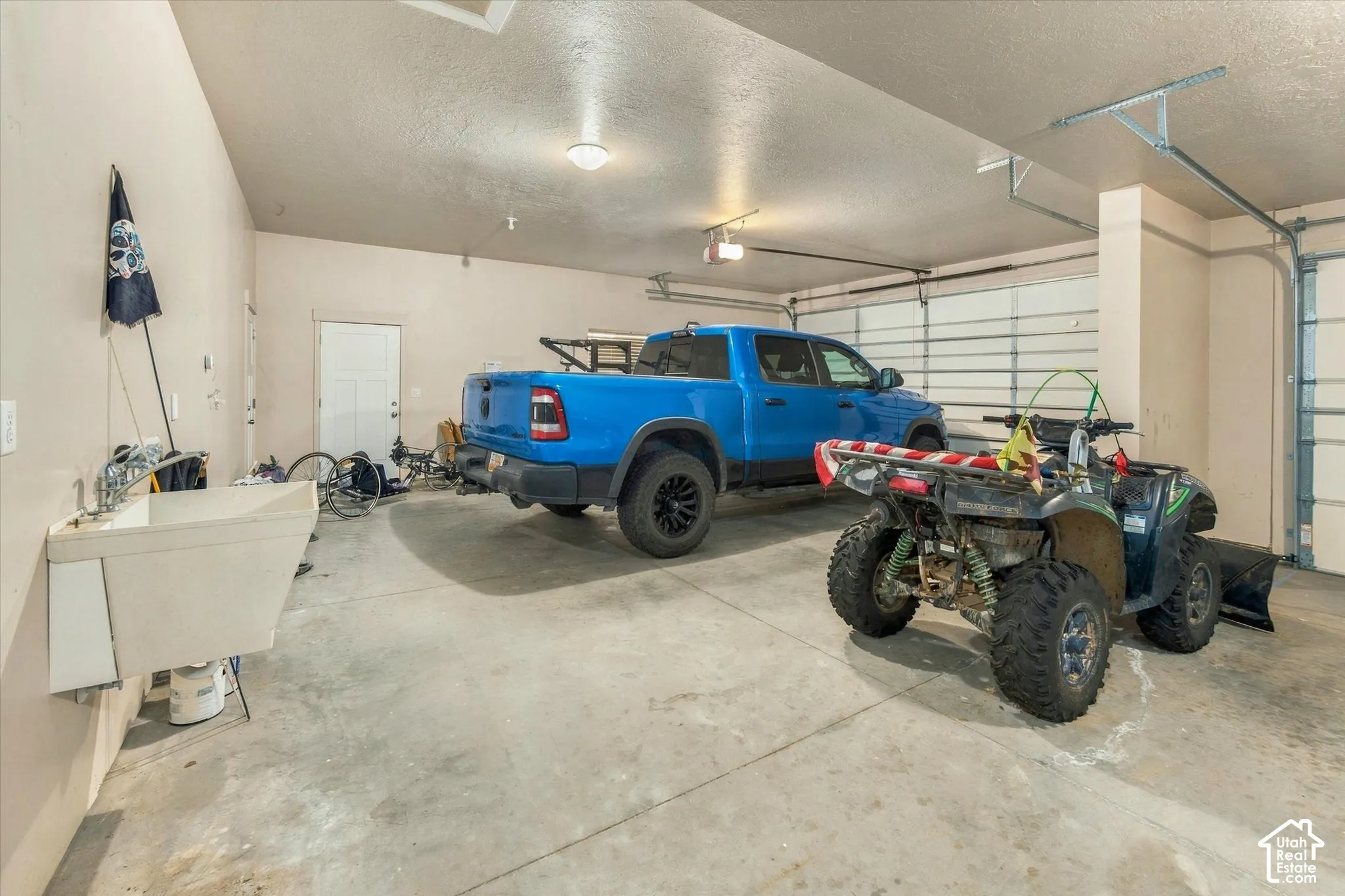 attached 4-car garage,utility sink, and overhead lighting