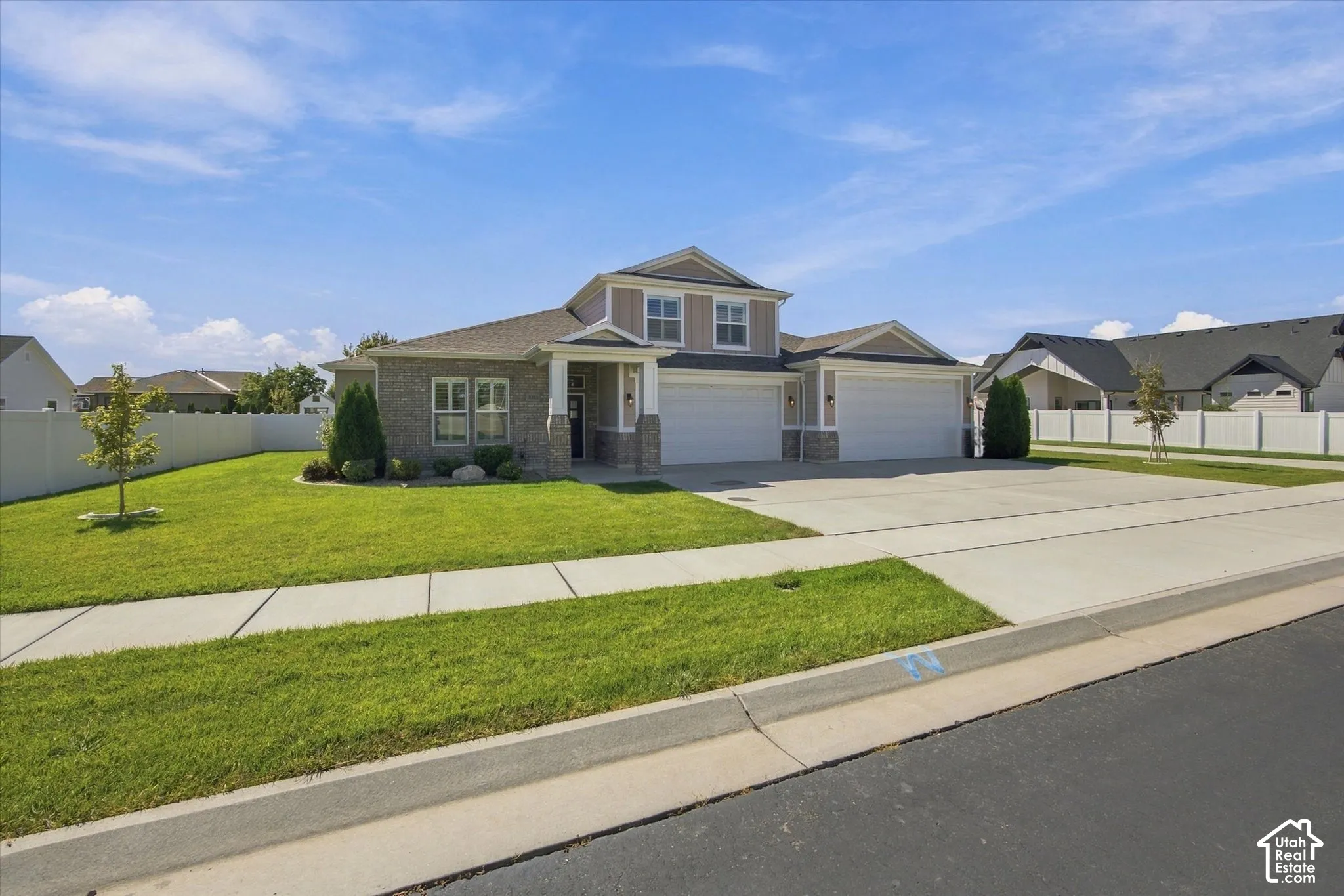 Brick Rambler w/ attached 4 car garage and well maintained yard.