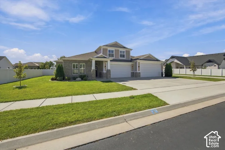 Brick Rambler w/ attached 4 car garage and well maintained yard.