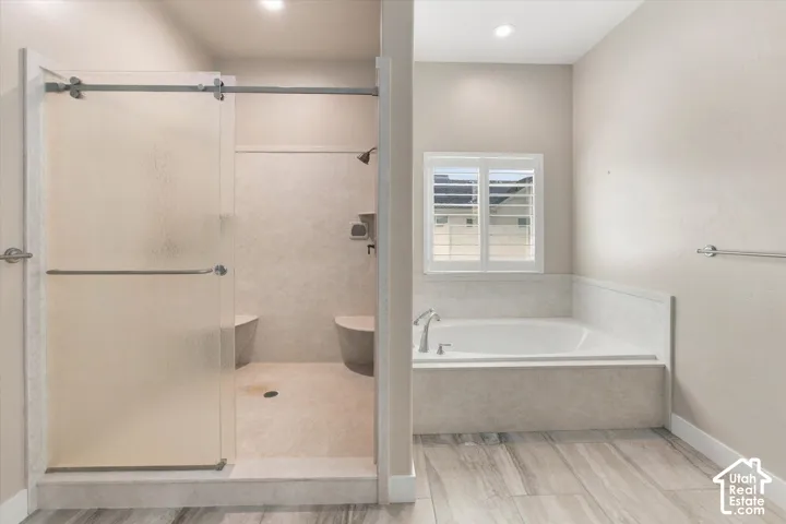 Master Ensuite featuring a built-in soaking tub, a walk-in shower