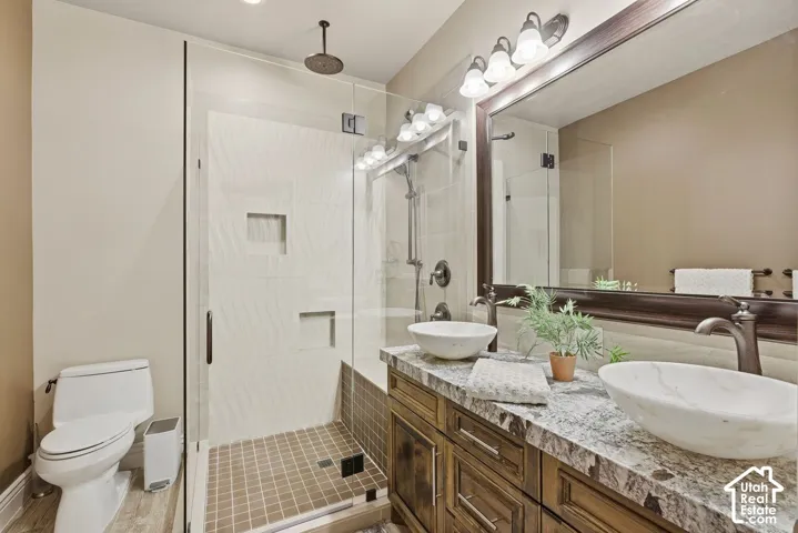 Lower level bathroom with double sink and walk in shower