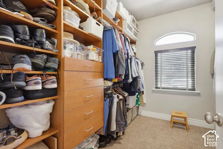 Primary bedroom walk in closet with tons of storage