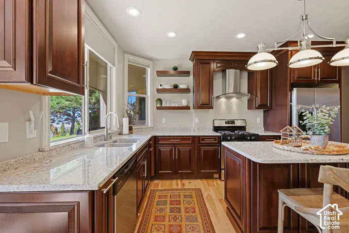 Lower level kitchen with stainless steel appliances, island, and solid surface countertops