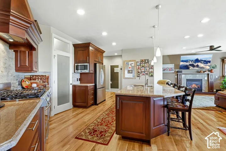 Welcoming entryway with warm hardwood flooring and sitting area