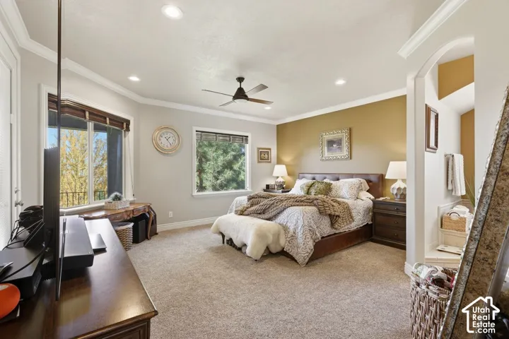 Main level primary retreat with direct access to the covered deck, walk-in closet, and spa-style ensuite