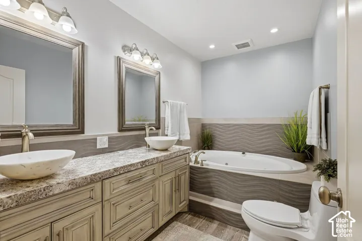 Lower level bathroom with double vanity and large tub