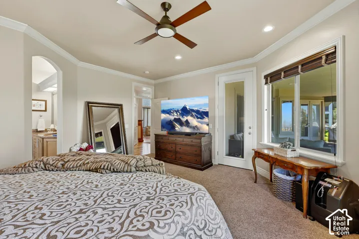 Main level primary retreat with direct access to the covered deck, walk-in closet, and spa-style ensuite