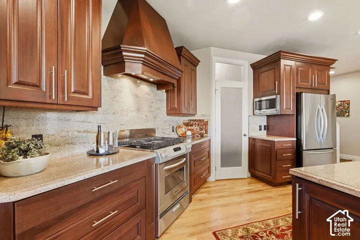 Welcoming entryway with warm hardwood flooring and sitting area