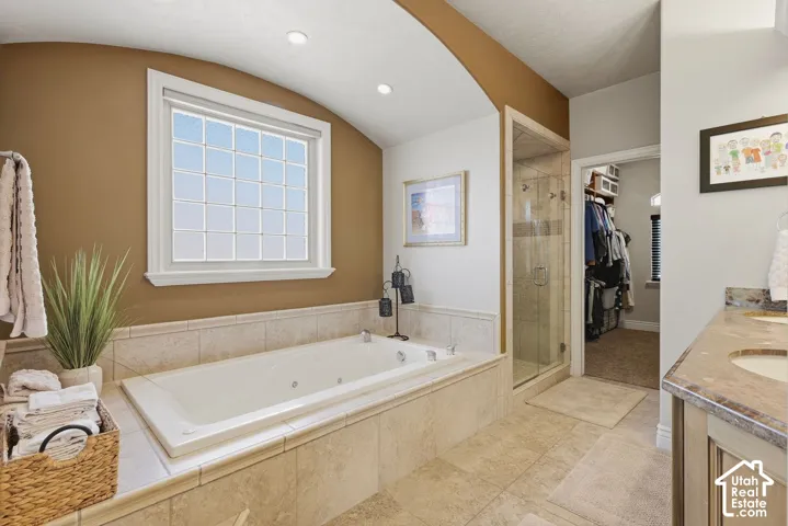 Spa-style ensuite featuring double vanity, oversized jetted tub and separate shower