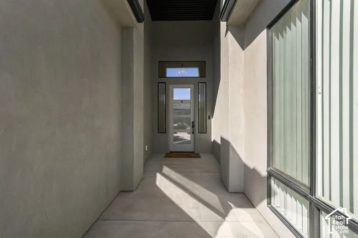 Recessed entryway featuring a glass-paneled door, transom window, and vertical sidelight windows