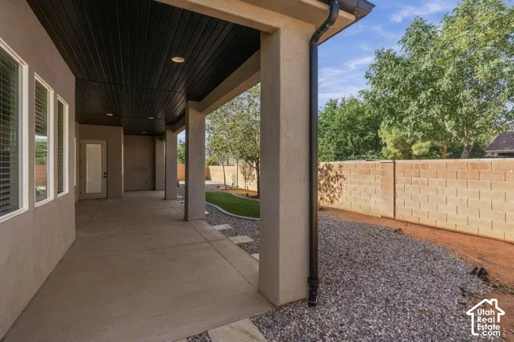 Covered patio featuring a dark wood-finish ceiling with recessed lighting