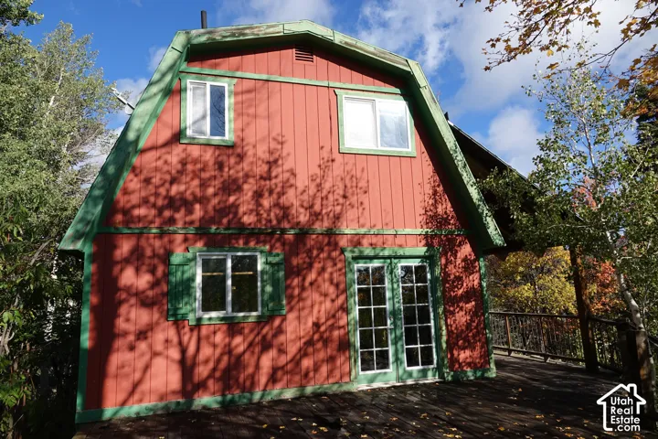 Red vertical siding exterior with green trim accents