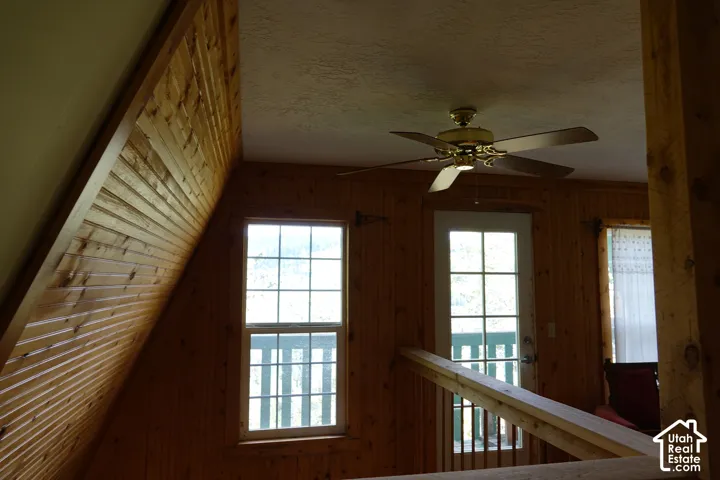 Wood railing with metal spindles, ceiling fan