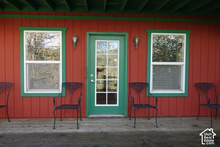 Red board-and-batten siding with green trim