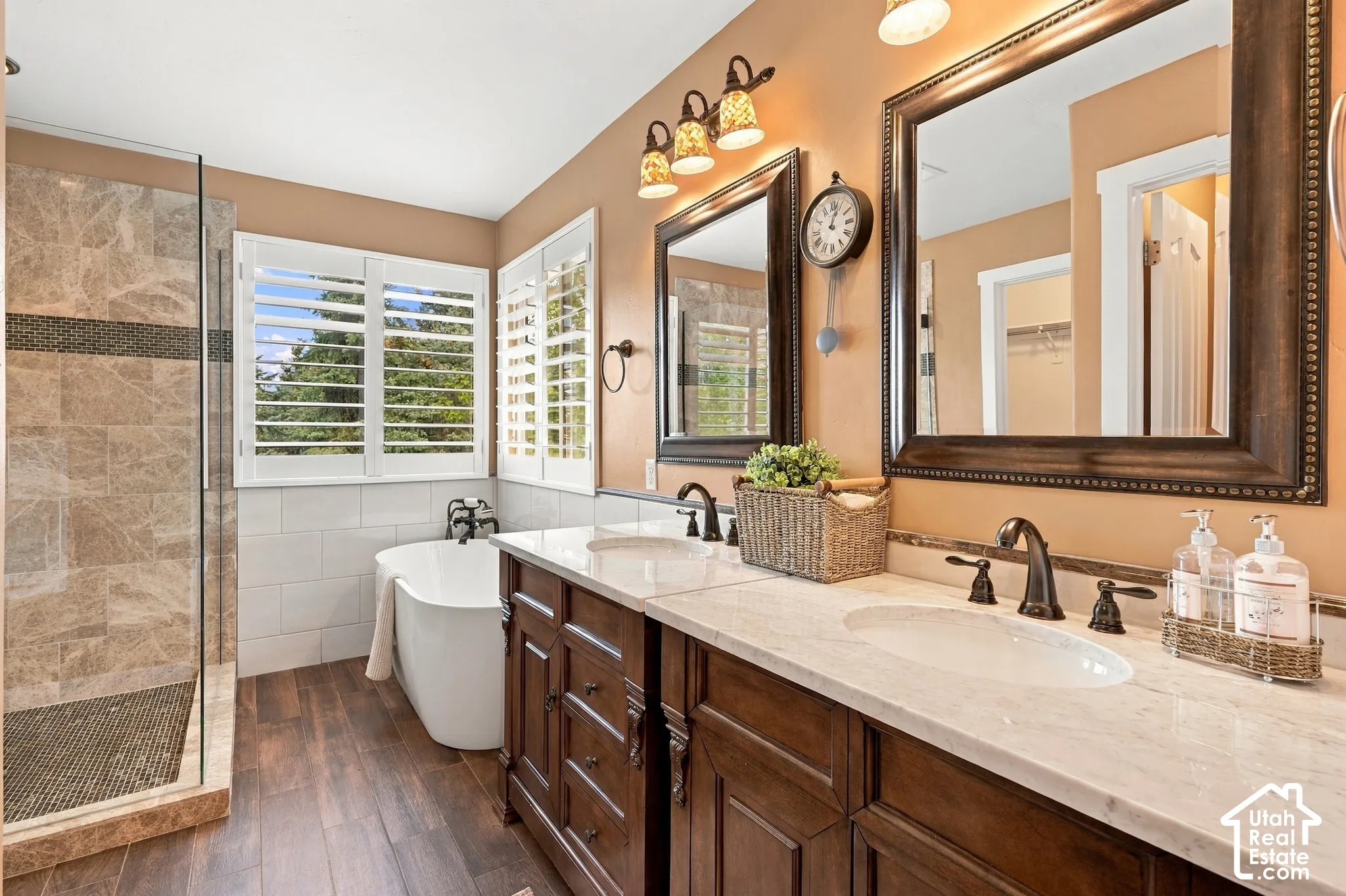 Dual vanity with stone countertops and bronze-finish fixtures