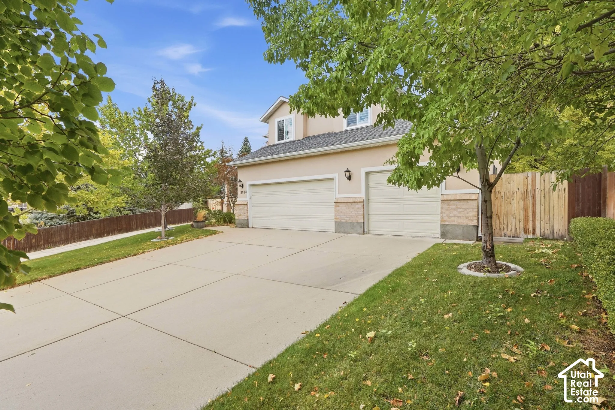 Two-story residence with a two-car garage and an additional single-car garage