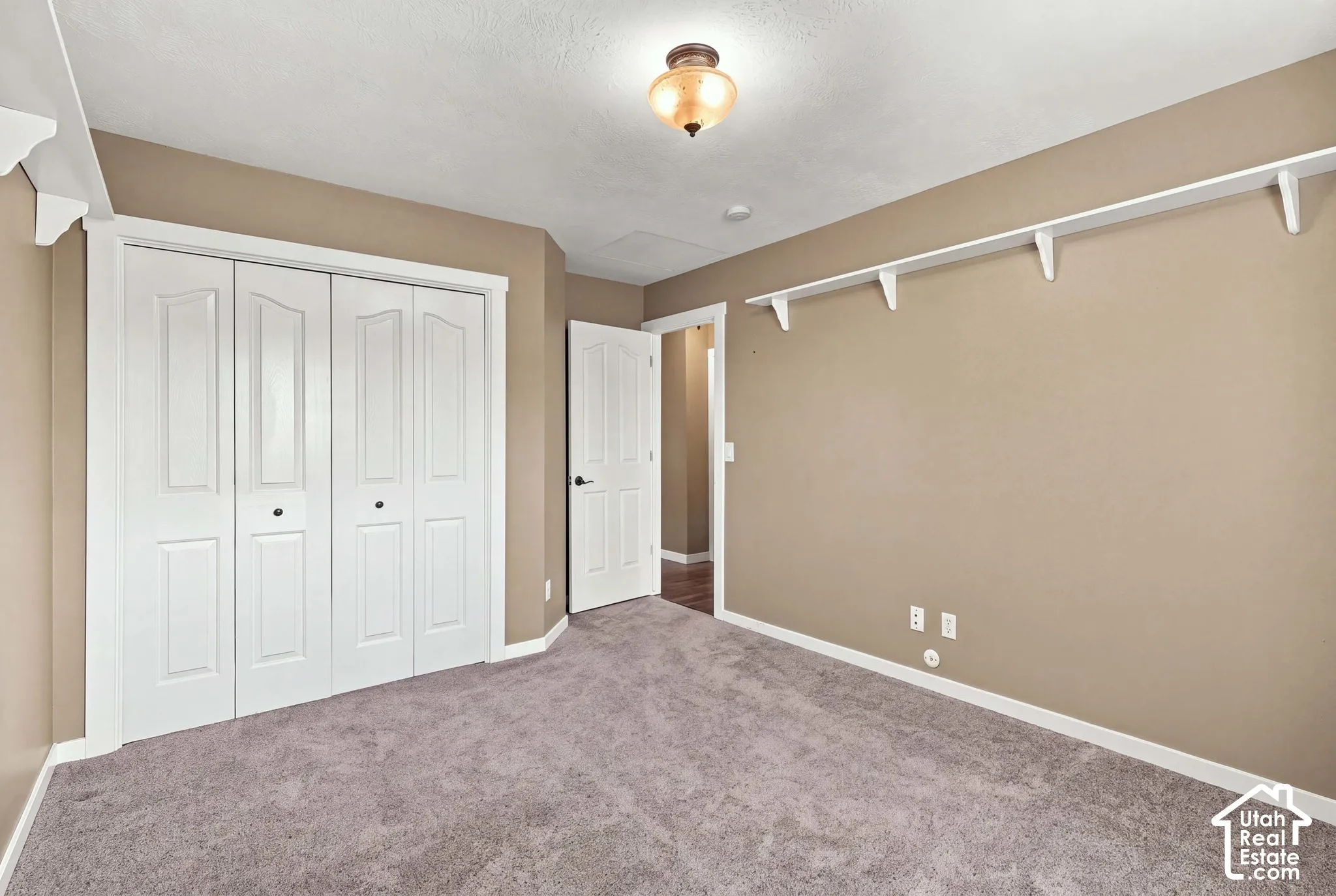 Neutral-toned walls complement the gray carpeting