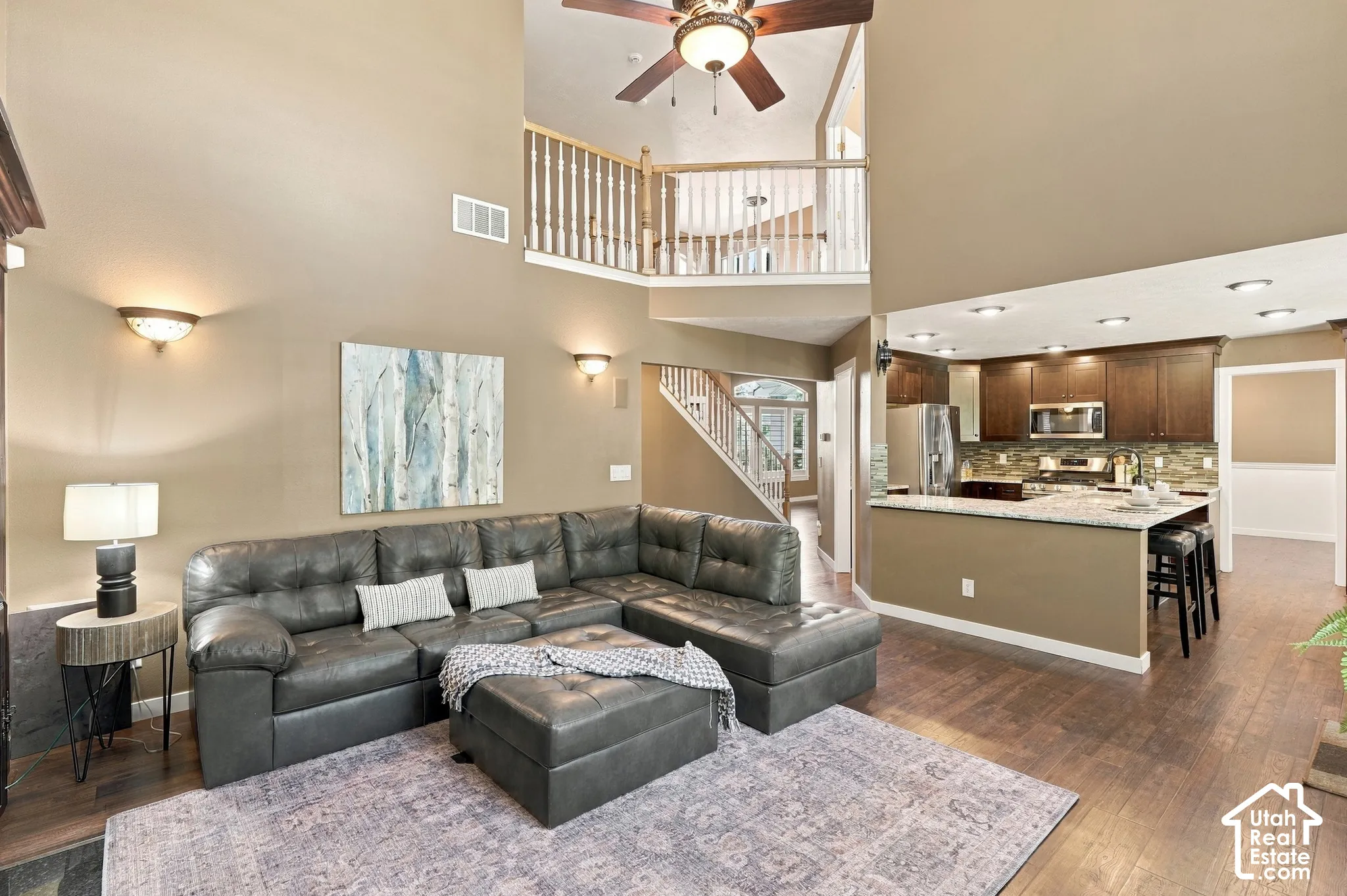 Vaulted ceilings and wood-finish flooring complement the open-concept design
