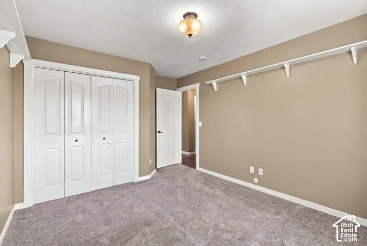Neutral-toned walls complement the gray carpeting