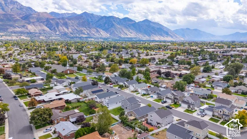 Residential neighborhood featuring mature trees and mountain scenery
