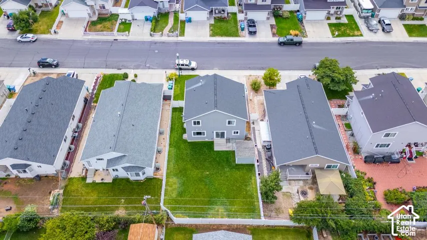 Contemporary single-family residence featuring a gray exterior, a dark gray shingle roof, and a green lawn