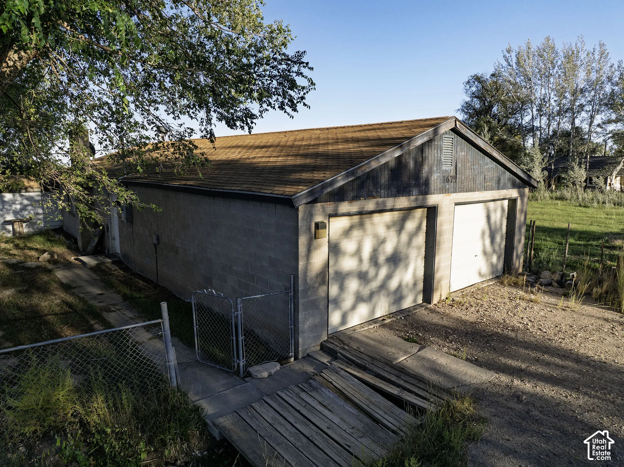 Two-car garage with overhead doors and a shingled roof