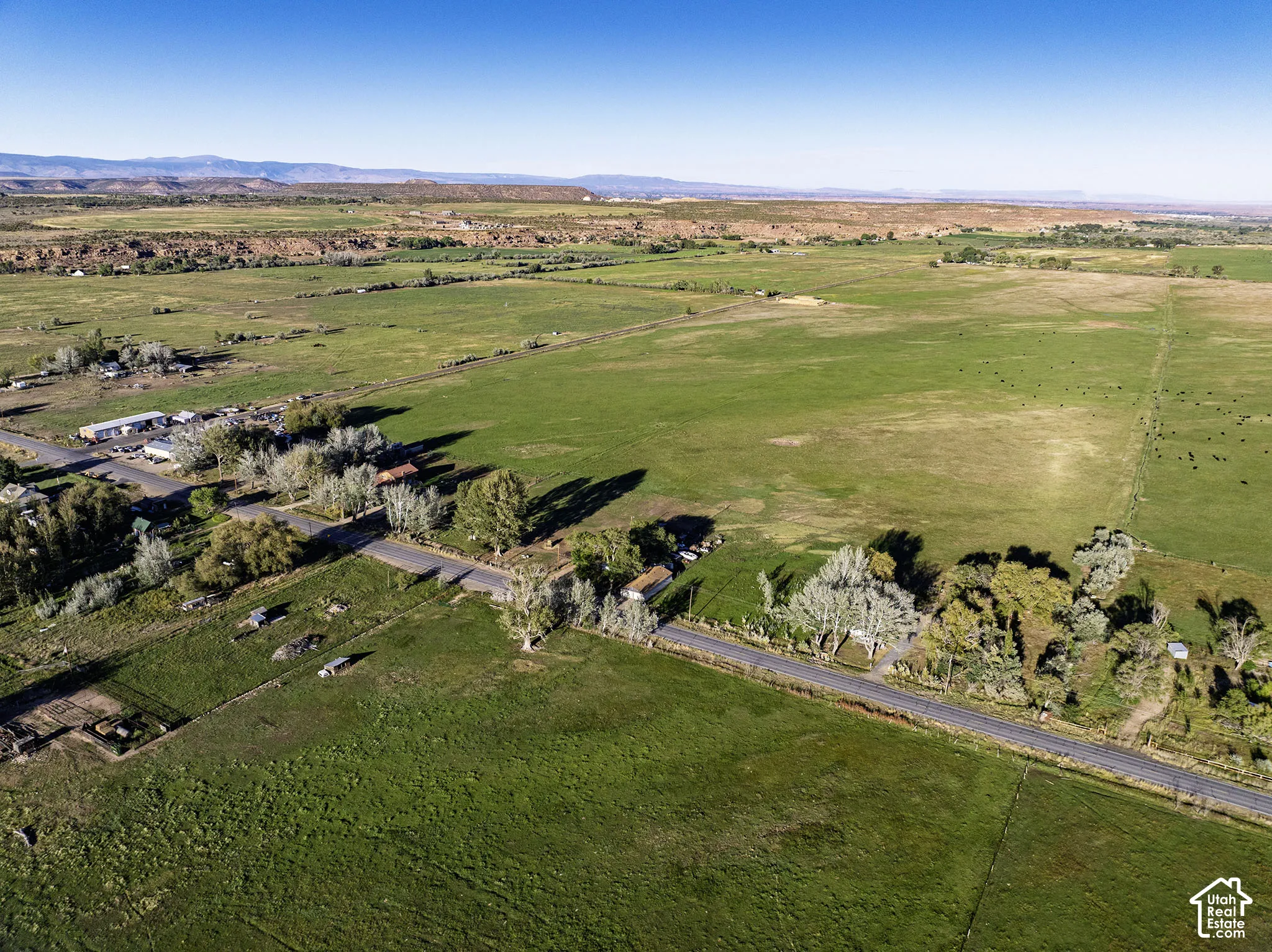 Expansive rural landscape with green fields and distant mountains