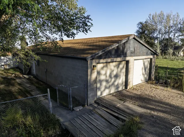 Two-car garage with overhead doors and a shingled roof