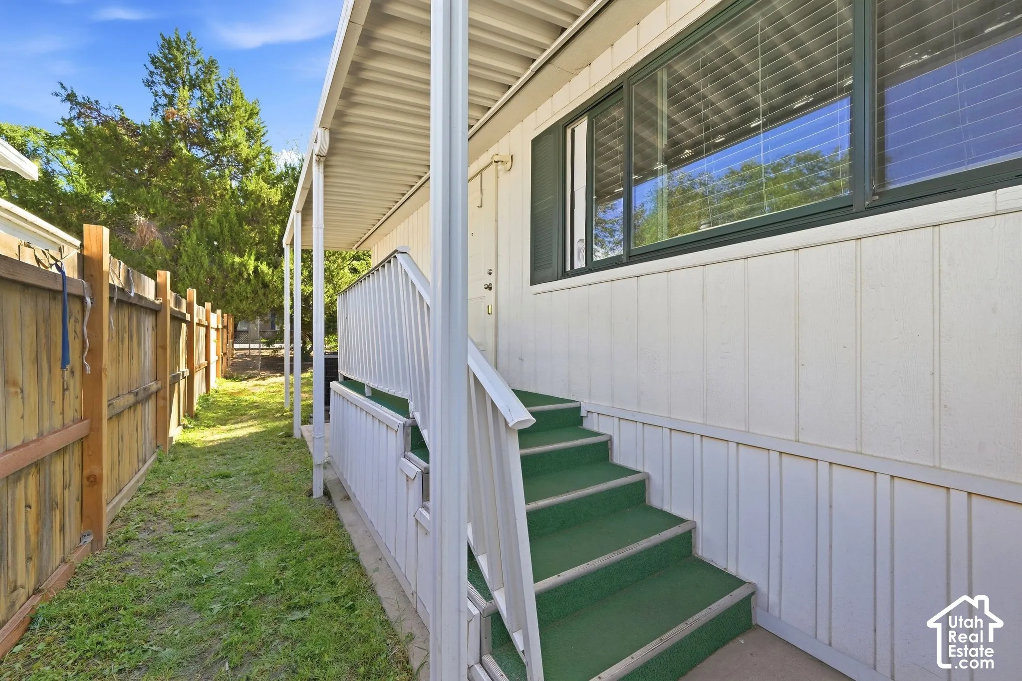 Covered entry porch with steps and railing
