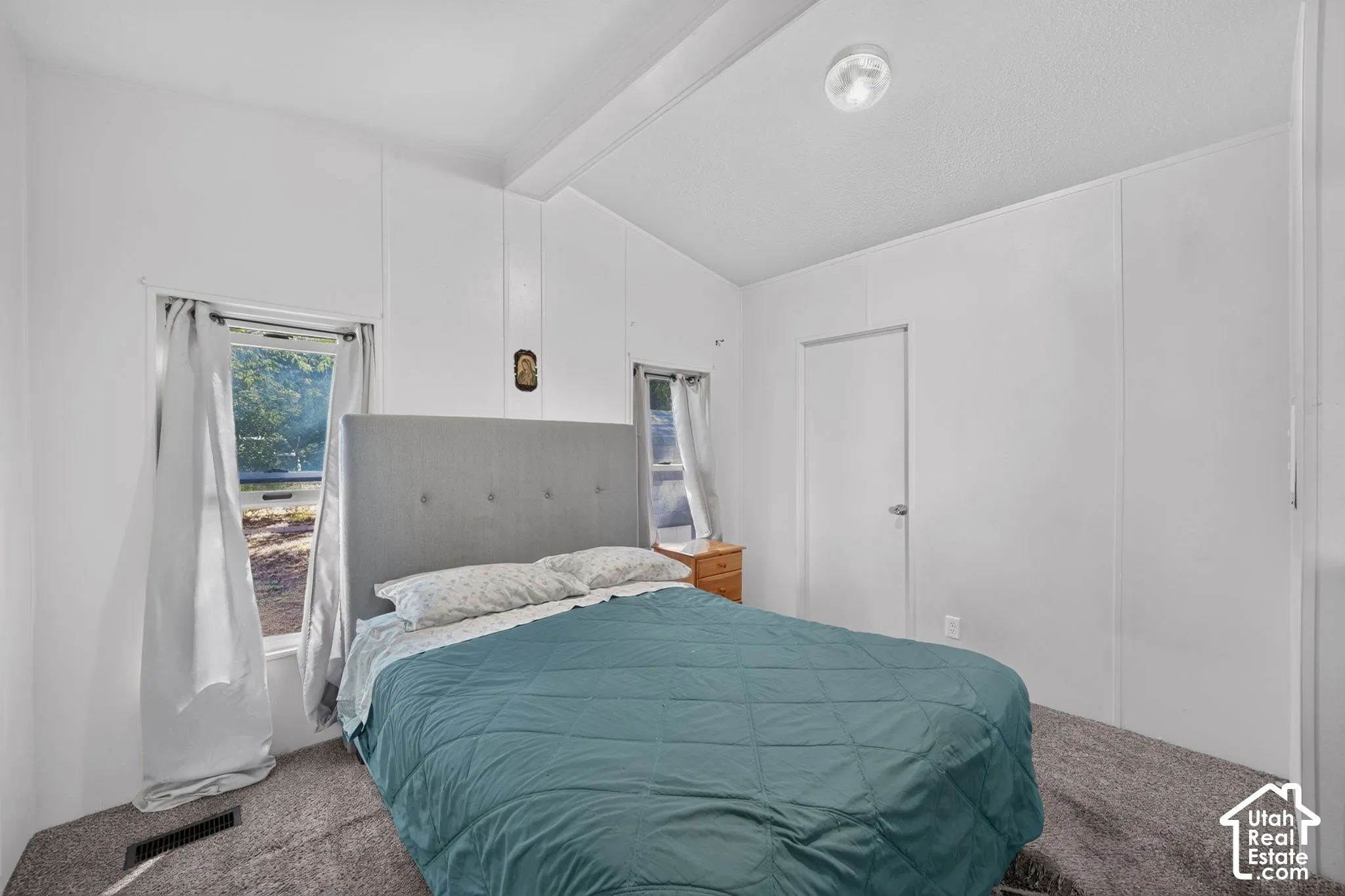 White paneled walls with a textured ceiling and recessed lighting