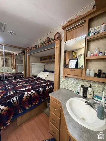 Wood-finish flooring with built-in bed frame