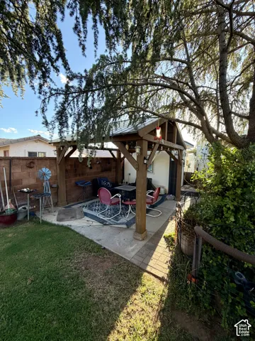 Concrete patio with a custom wooden pergola structure