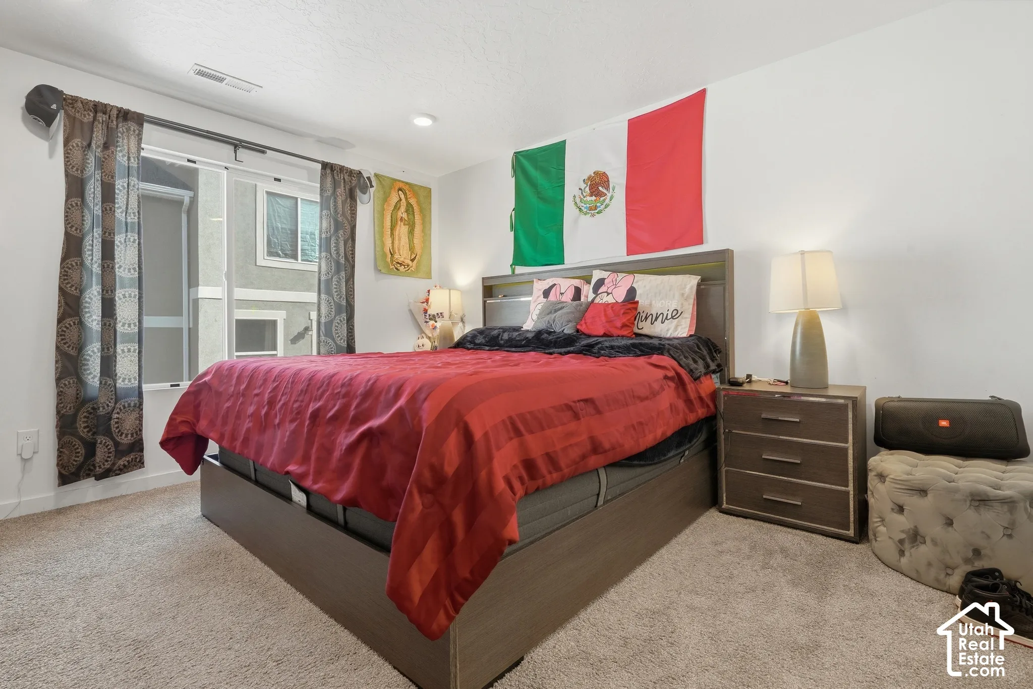 Plush carpet flooring, recessed ceiling lighting, and a sliding glass door