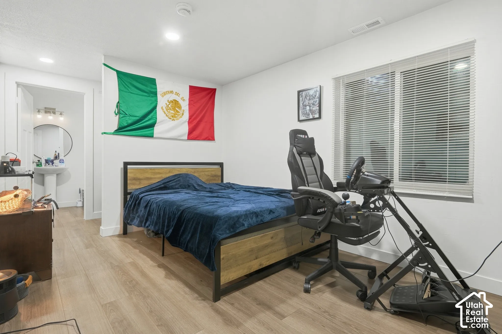 Recessed lighting, wood-finish flooring, and a large window with blinds