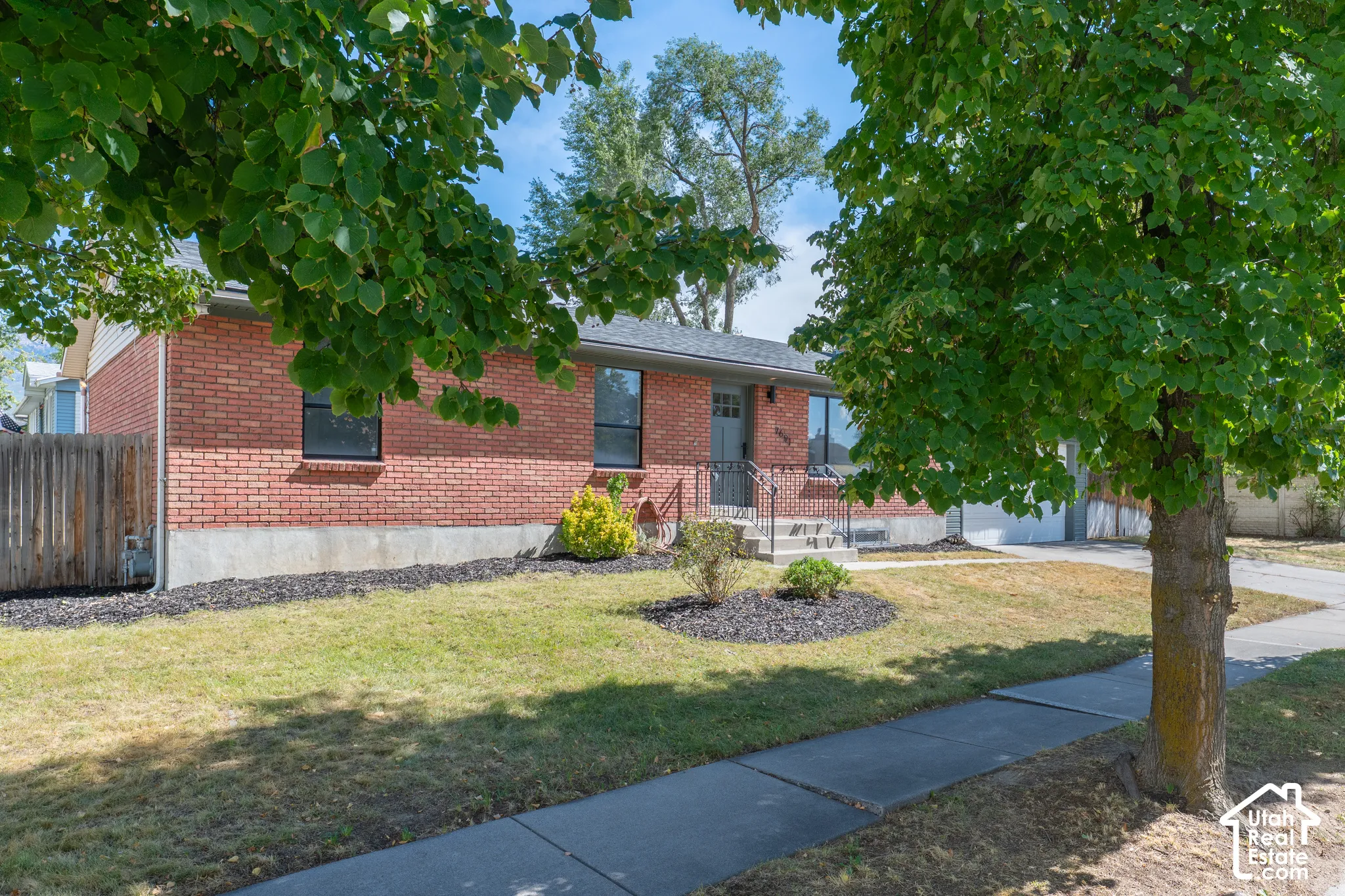 Red brick exterior with a gray roof and concrete foundation