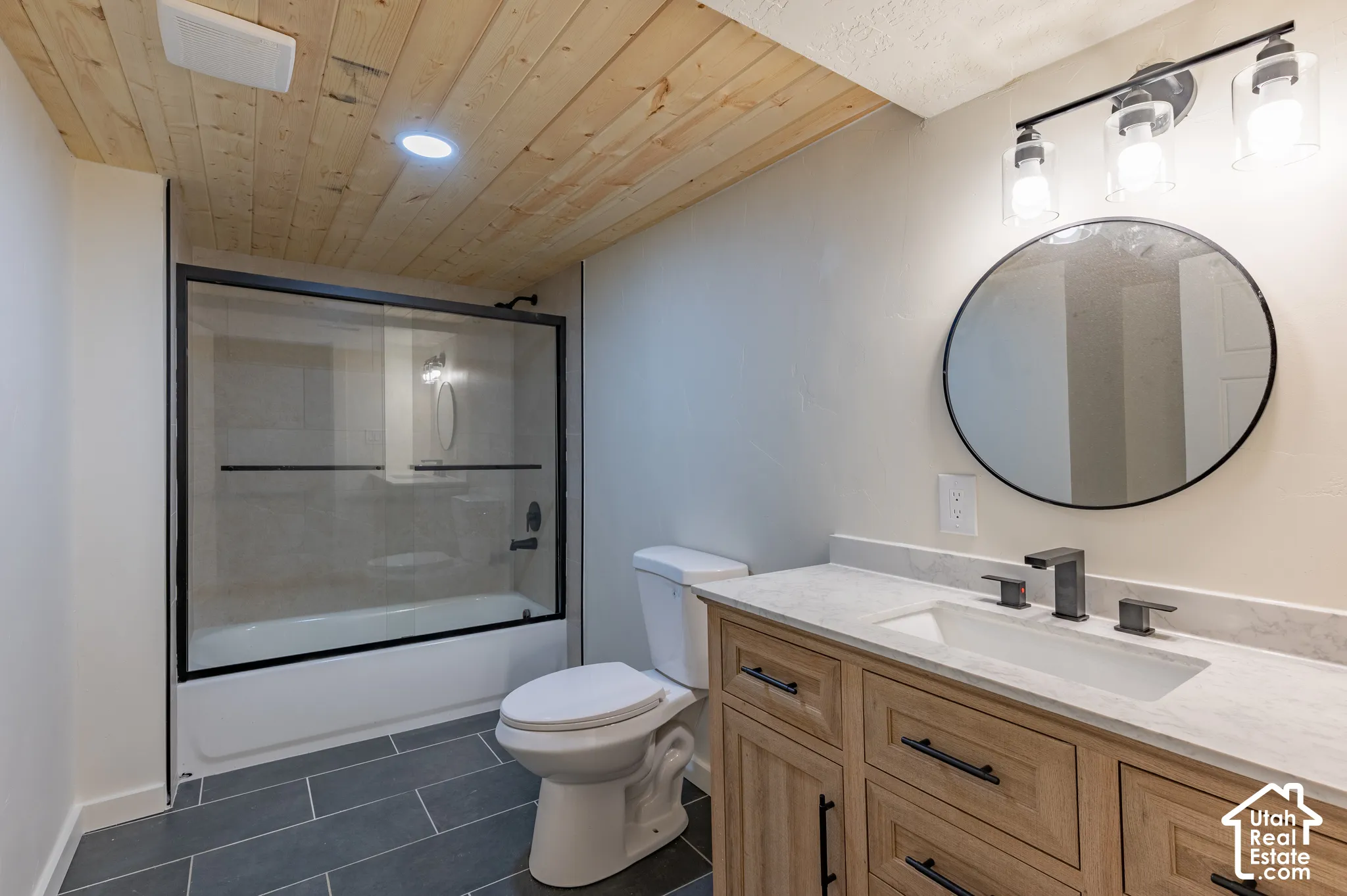 Wood plank ceiling with recessed lighting